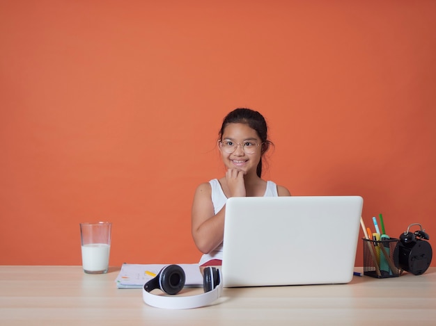 girl having online studying with laptop at home