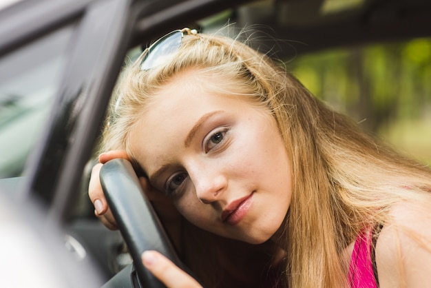 Girl head on steering wheel