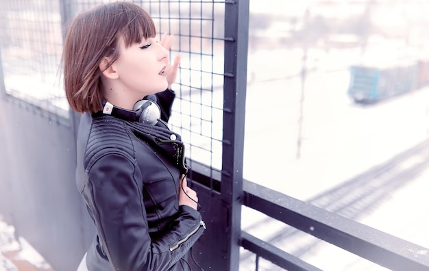 Girl in headphones listening to music outdoors