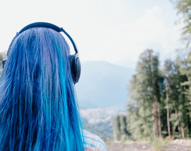 Girl in headphones outdoor.