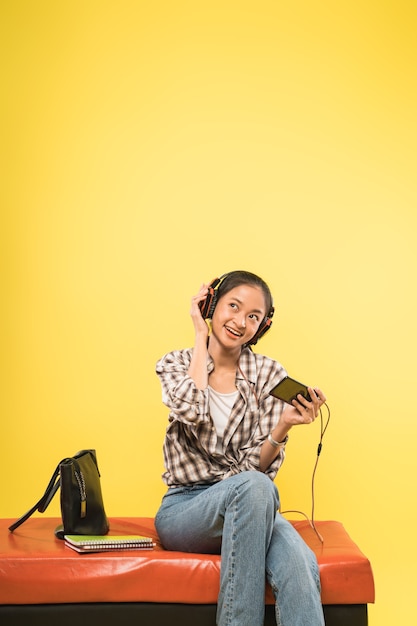 Girl headphones playing game using a mobile phone