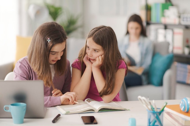 Girl helping her younger sister with her homework