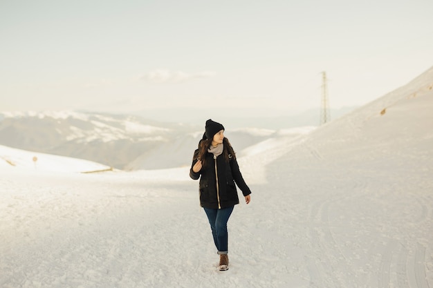 Girl on high of the snowy mountains.