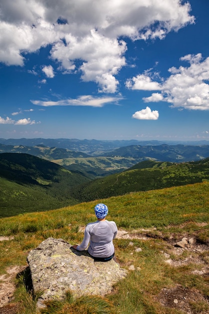 Girl hiker in the mountains with a beautiful view of the Carpathians