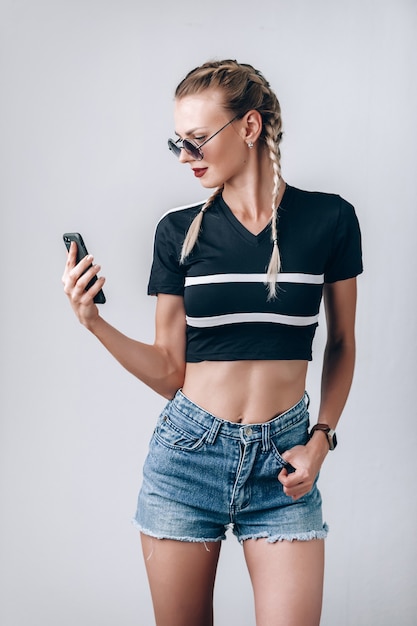 Girl hipster with sunglasses with phone