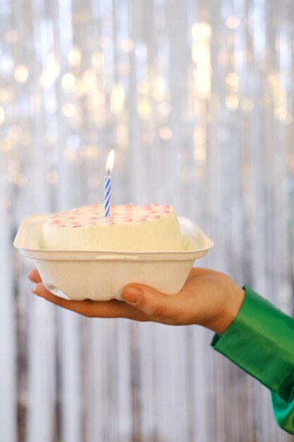 Girl Hold Bento Cake Decorated By red hearts against the background of silver tinsel Cakes For One Person One Candle In the middle of cake