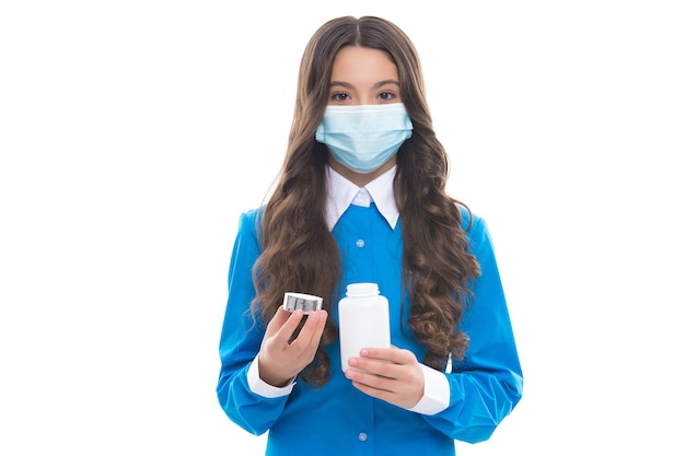 Girl hold vitamins or medicine drug pills from fever wearing protective medical mask isolated on white, corona virus.