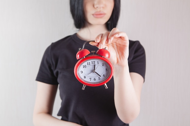 Girl holding an alarm clock