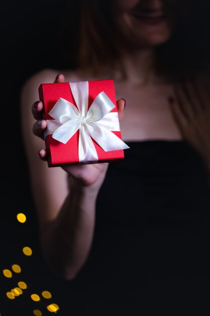 Girl holding beautiful  gift for  day valentines day