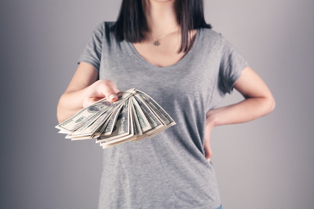 Girl holding big money in her hands