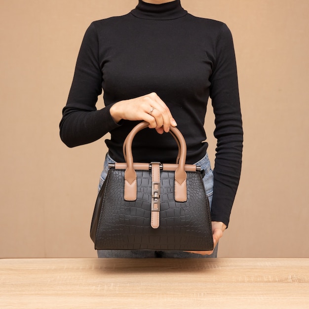 Girl holding black bag in hands