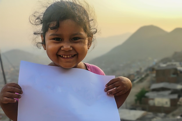 Girl holding a blank sheet of paper to insert a text or message