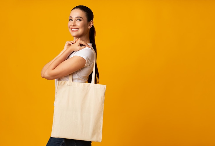 Girl Holding Blank White Eco Bag On Yellow Background