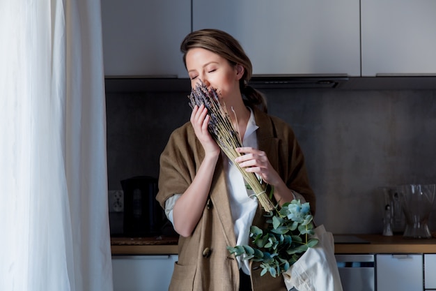 girl holding a bouquet of lavender and a rag bag