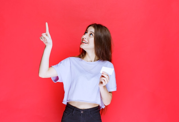 Girl holding a business card