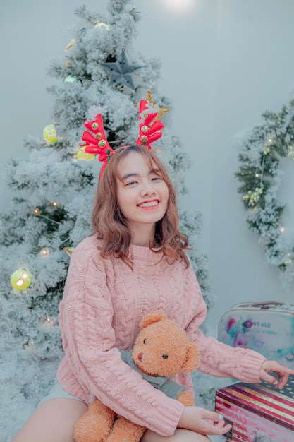 girl holding a christmas bear