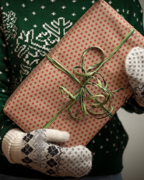 Girl holding a Christmas gift. 