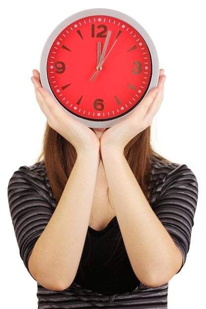 Girl holding clock over face isolated on white