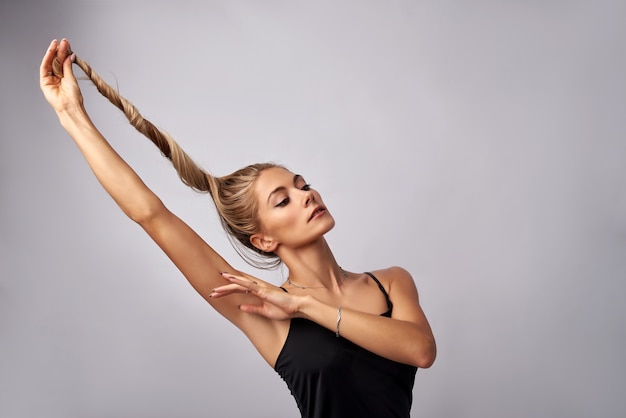 girl holding curled hair in the studio on a white