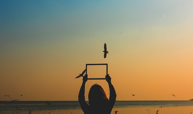 Photo girl holding an empty frame border silhouette