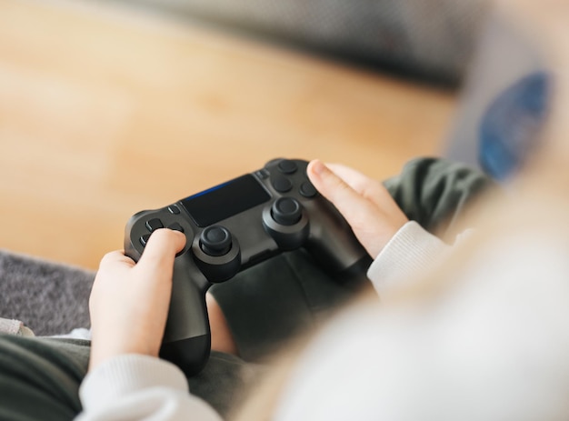 A girl holding game controller playing video games