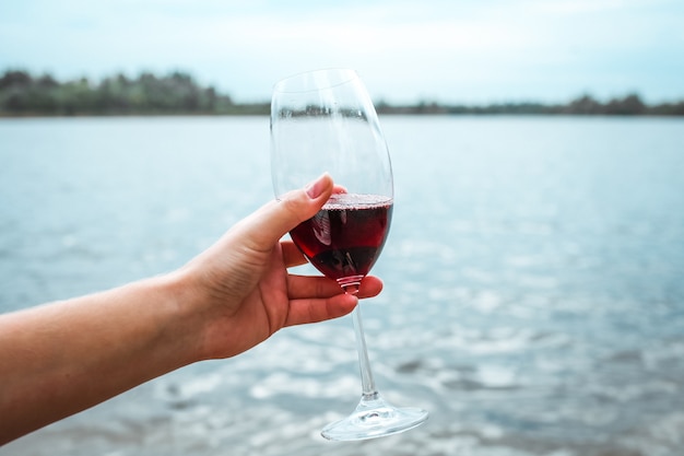 Girl holding a glass of red wine in her hand