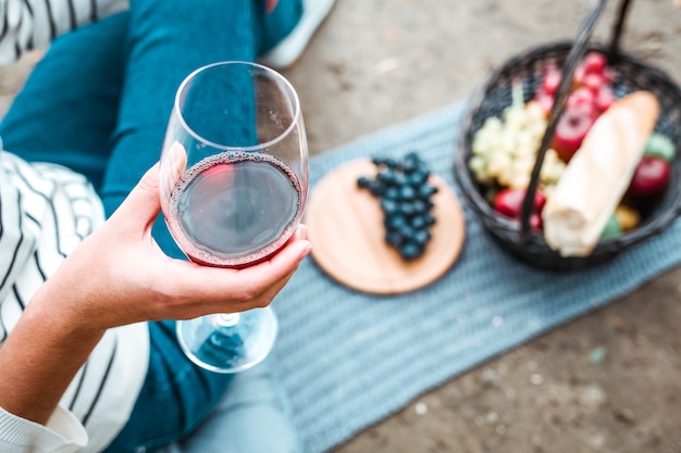 Girl holding a glass of red wine in her hand