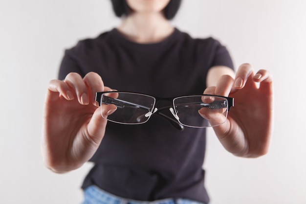 Girl holding glasses in her hand