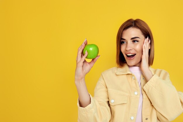 Girl holding green apple isolated on white background person