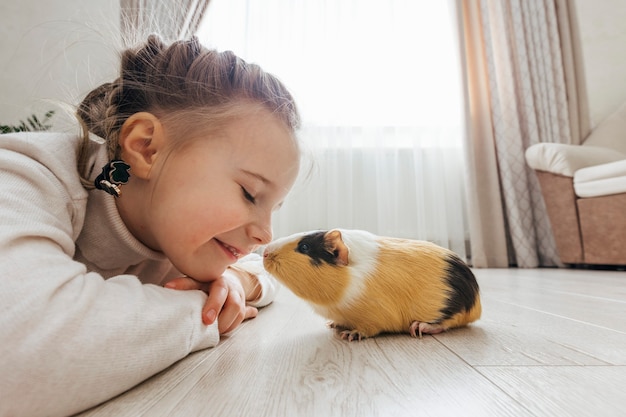 Girl holding a guinea pig in her arms