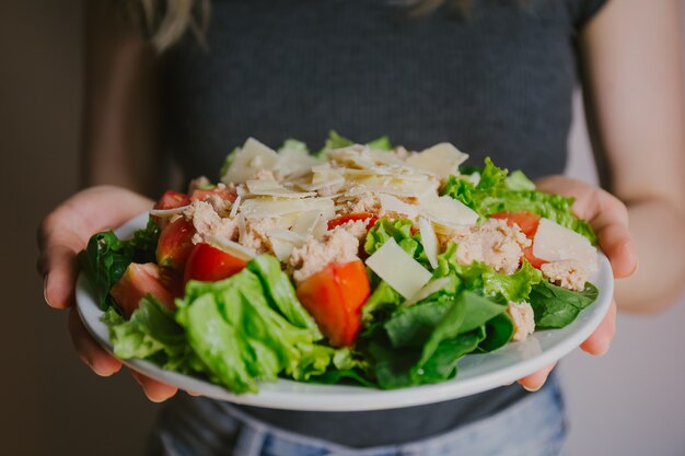 Girl holding healthy salad ready to eat