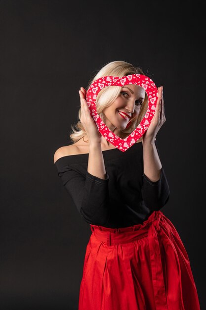 Girl holding a heart at eye level red flirting on the floor\
hearts wedding inspiration banner love