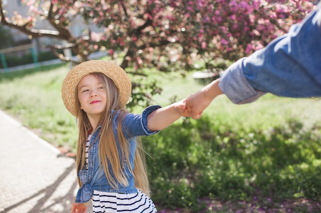 Girl holding her mother's hand