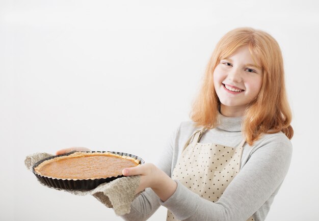 Girl holding  homemade pie in her hands