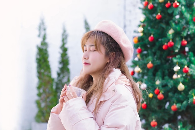 The girl holding a hot water cup in the warm winter