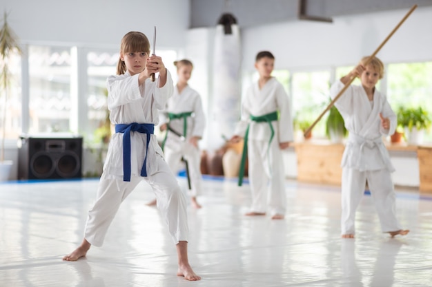 Girl holding knife. Girl holding knife practicing aikido movements at the lesson