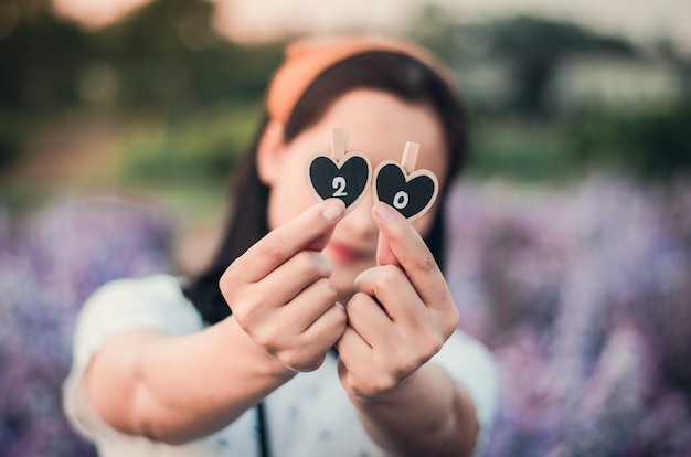 girl holding little clothespin with number