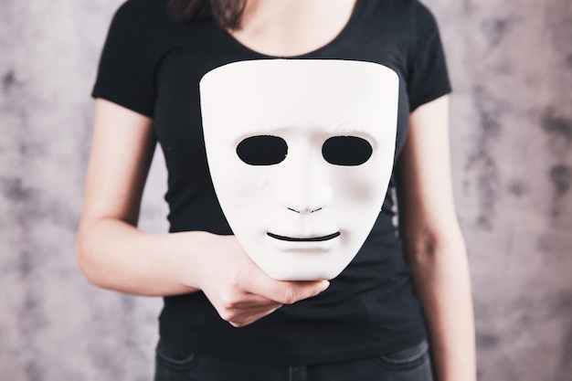 Girl holding a mask in her hand