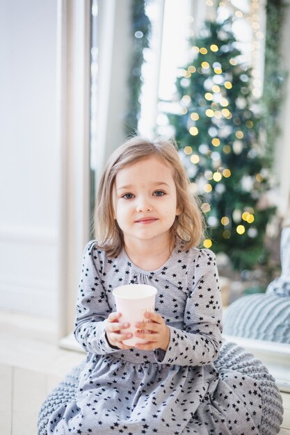 Girl holding a mug at home on Christmas