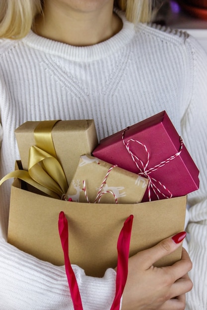 Girl holding New Year's gifts in her hands.