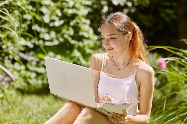 Girl holding an online meeting and chat in nature