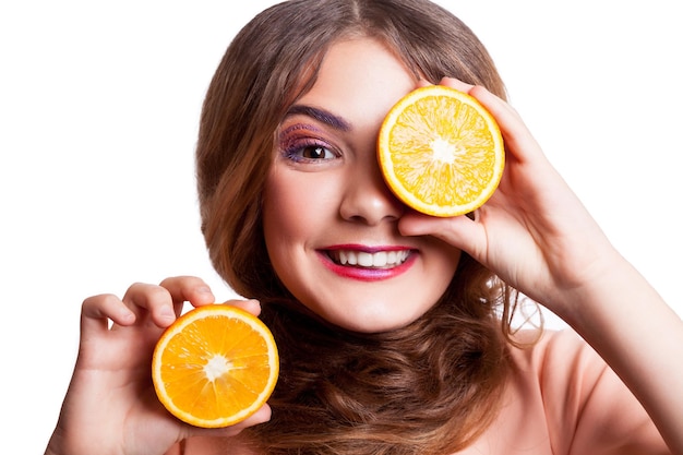 Girl holding orange on white backgrond