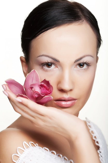 Girl holding orchid flower