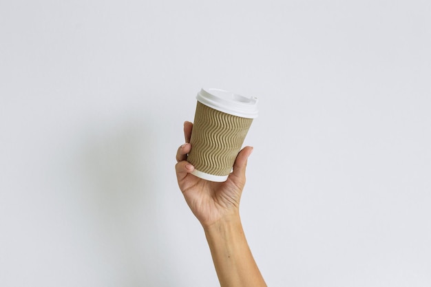 Girl holding a paper cup for coffee