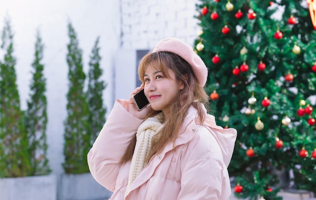 The girl holding a phone in the warm winter