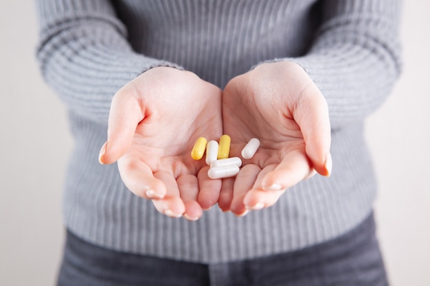 Girl holding pills in her hands