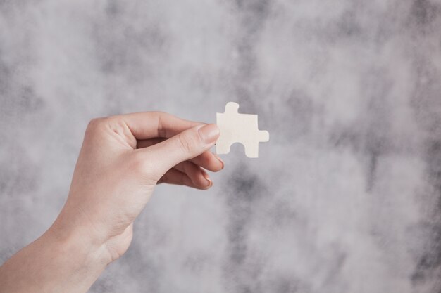 Girl holding a puzzle in her hand