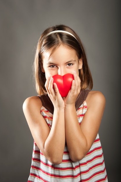 Girl holding red heart