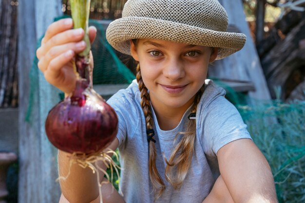 Girl holding red onion