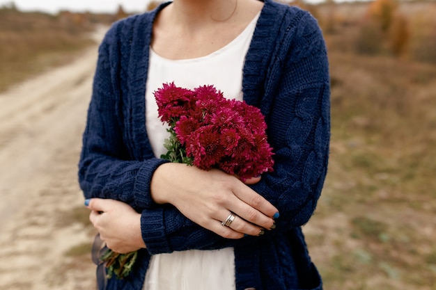 Girl holding red peonies. Present from boyfriend. High quality photo